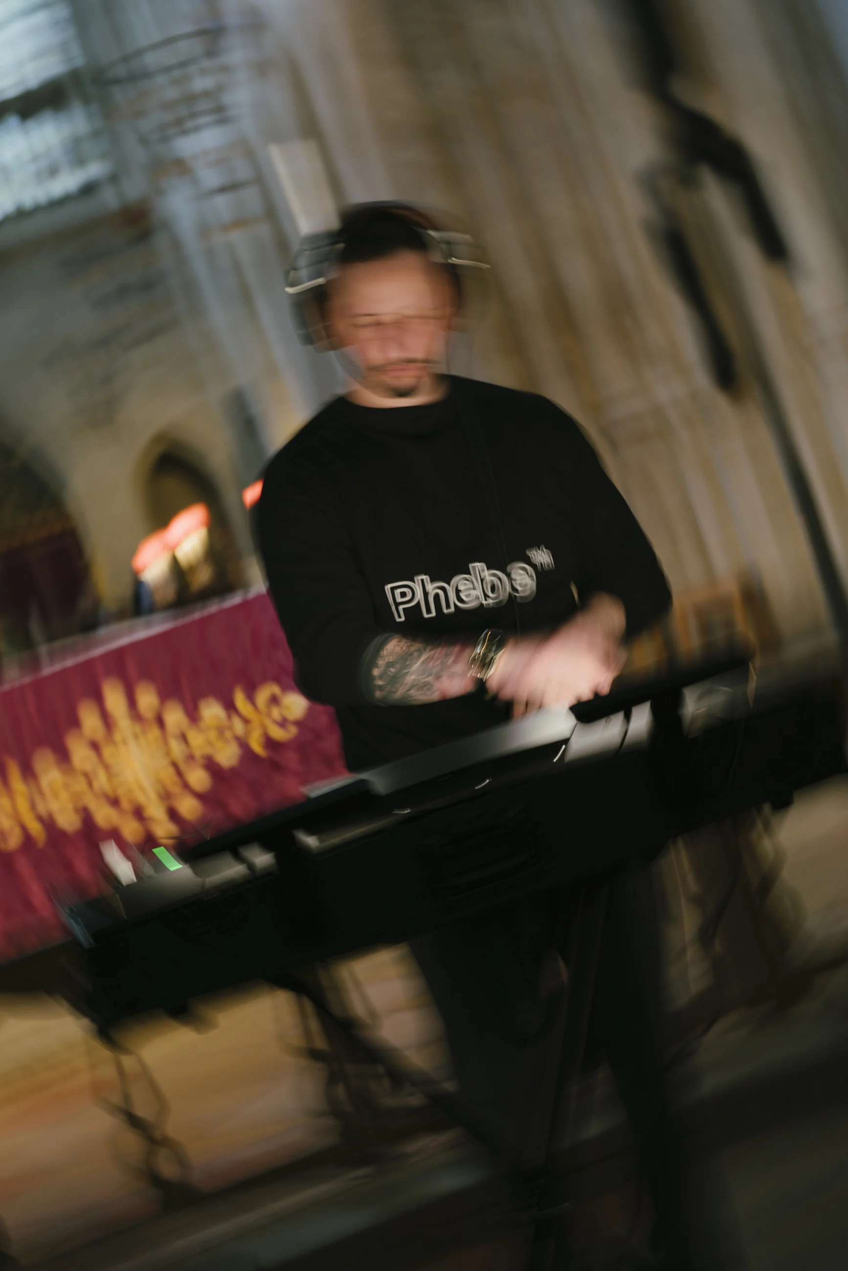 DJ Daniel performing with headphones and turntables